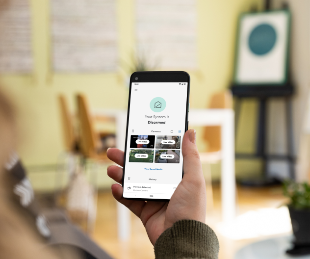 Someone disarming their home with the ADT app