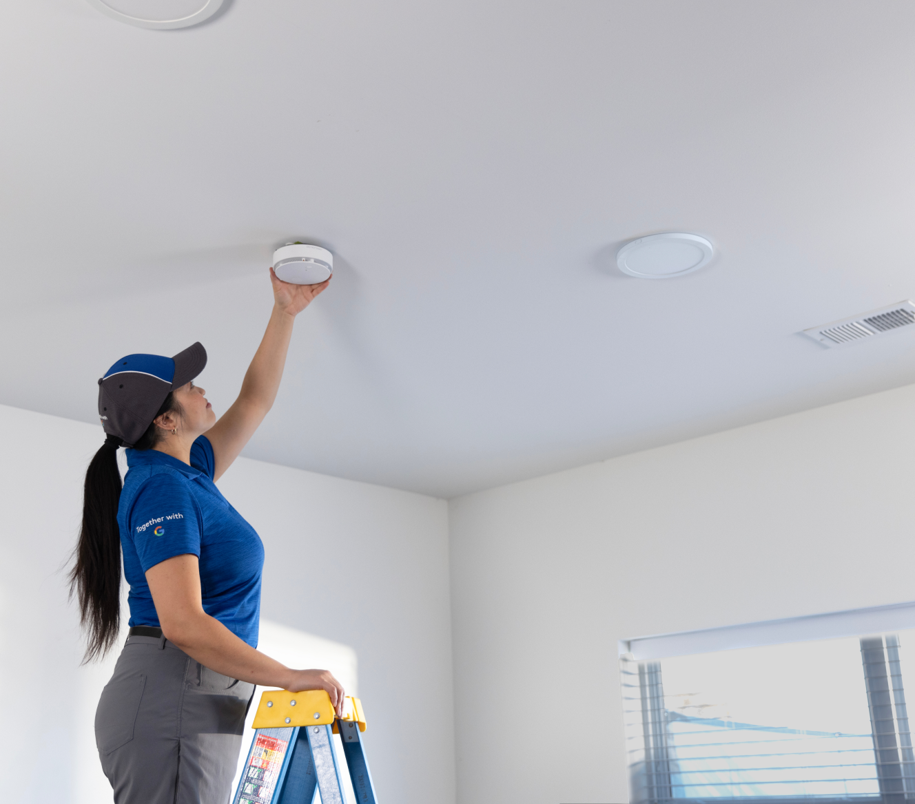 ADT employee installing an ADT Battery Smoke Detector