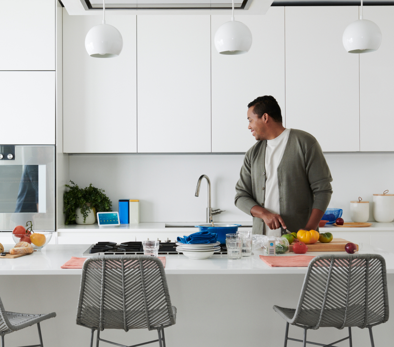 Man using voice control with his Google Nest Hub 2 Gen in the kitchen