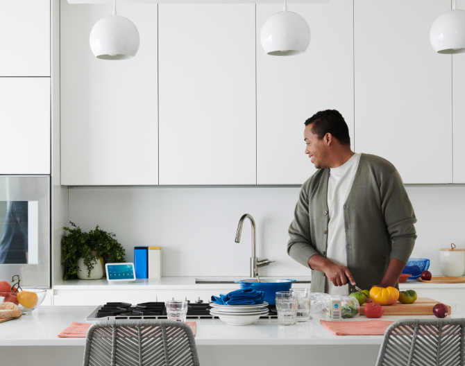 Man using voice control with his Google Nest Hub 2 Gen in the kitchen